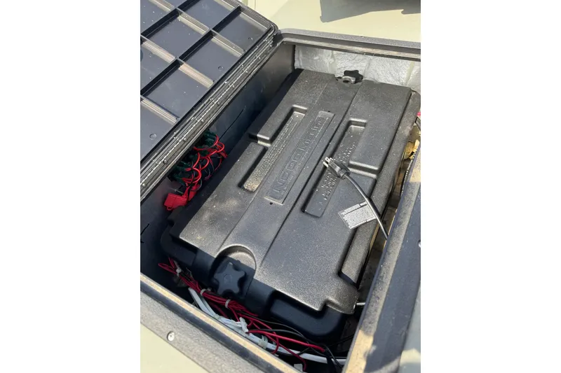 Slide: The Image of Battery compartment of a 2021 Weldcraft 15 boat, featuring wiring and connectors. - 18