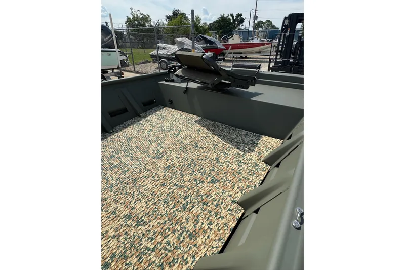 Slide: The Image of 2021 Weldcraft 15 boat interior with camouflage flooring and mounted equipment. - 22