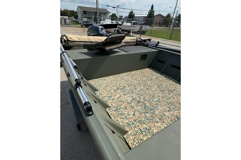 Slide: The Image of 2021 Weldcraft 15 boat interior with camouflage flooring and mounted equipment. - 23