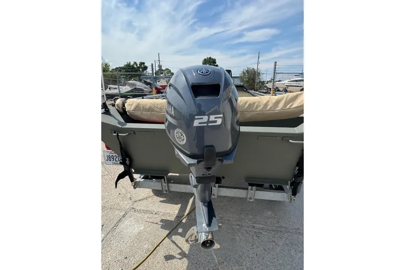 Slide: The Image of 2021 Weldcraft 15 boat with Yamaha 25 outboard motor, parked outdoors. - 24