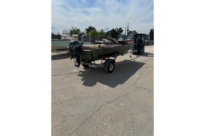 Slide: The Image of 2021 Weldcraft 15 boat on trailer, parked outdoors under a partly cloudy sky. - 3