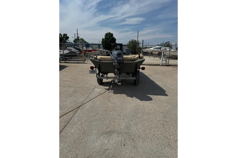 Slide: The Image of 2021 Weldcraft 15 boat on trailer, parked outdoors under a clear sky. - 4