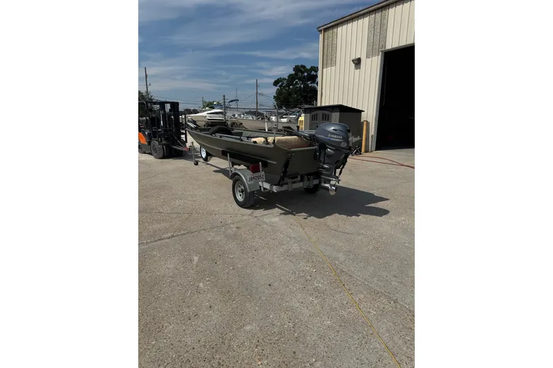 Slide: The Image of 2021 Weldcraft 15 boat on trailer outside a warehouse, featuring a Yamaha outboard motor. - 5