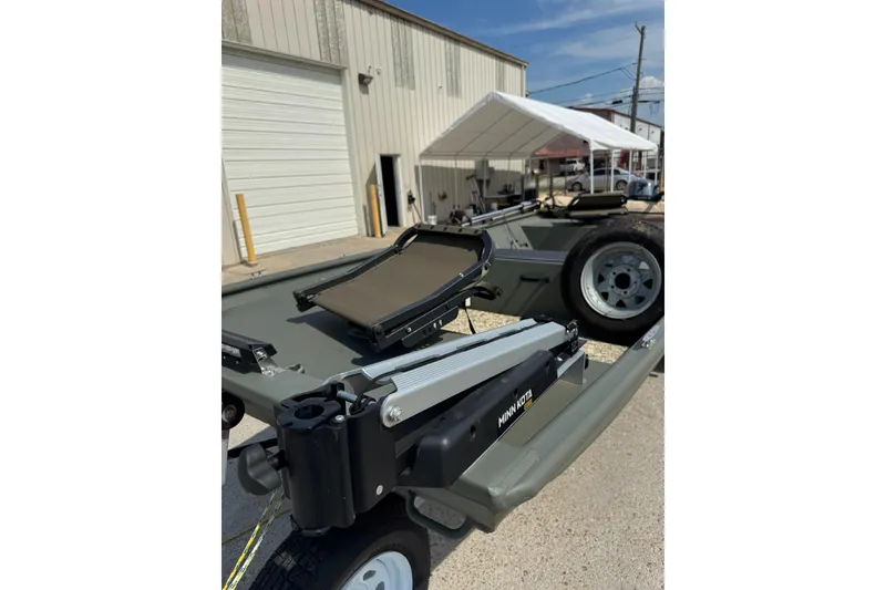 Slide: The Image of 2021 Weldcraft 15 boat with Minn Kota motor, parked outside a building. - 9