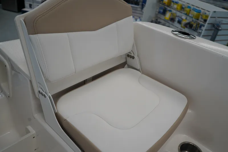 Slide: The Image of 2026 Robalo R160 Center Console boat seat, beige and white upholstery, showroom display. - 10