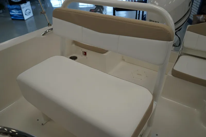 Slide: The Image of 2026 Robalo R160 Center Console boat interior with beige and white seating. - 12
