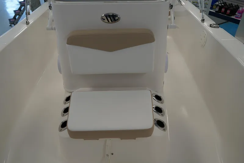 Slide: The Image of 2026 Robalo R160 Center Console boat interior with cushioned seating and rod holders. - 15
