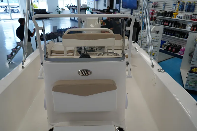 Slide: The Image of 2026 Robalo R160 Center Console boat interior in showroom setting. - 16