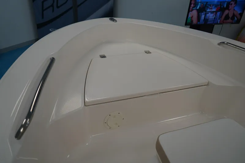 Slide: The Image of 2026 Robalo R160 Center Console boat interior with storage compartment and stainless steel handrails. - 17