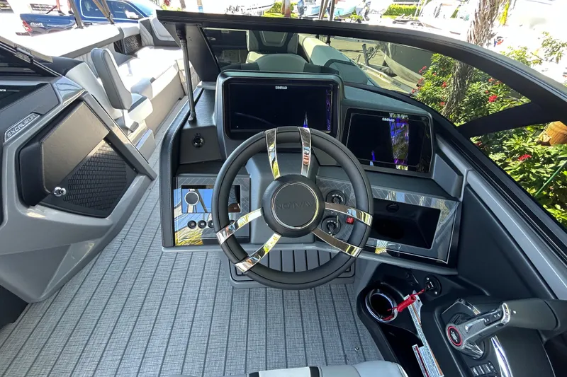 Slide: The Image of Interior view of 2026 Avalon Excalibur boat cockpit with modern steering and controls. - 7