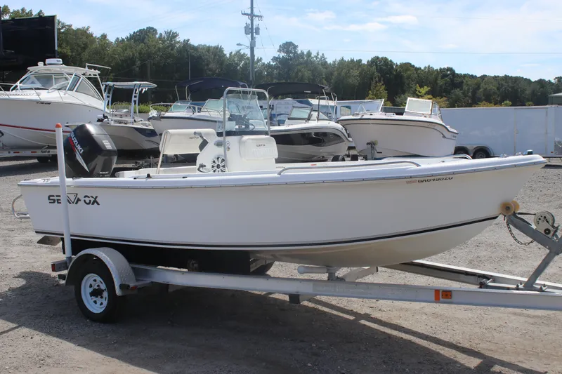Slide: The Image of 2007 Sea Fox 172 Center Console boat on trailer, parked in a marina lot. - 3