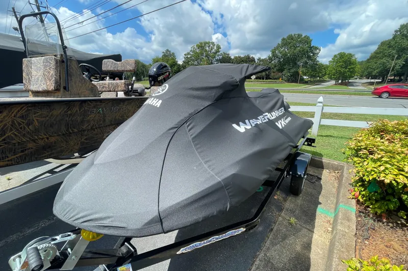 Slide: The Image of 2021 Yamaha WaveRunner VX Cruiser HO covered, parked on a trailer in a sunny outdoor setting. - 9