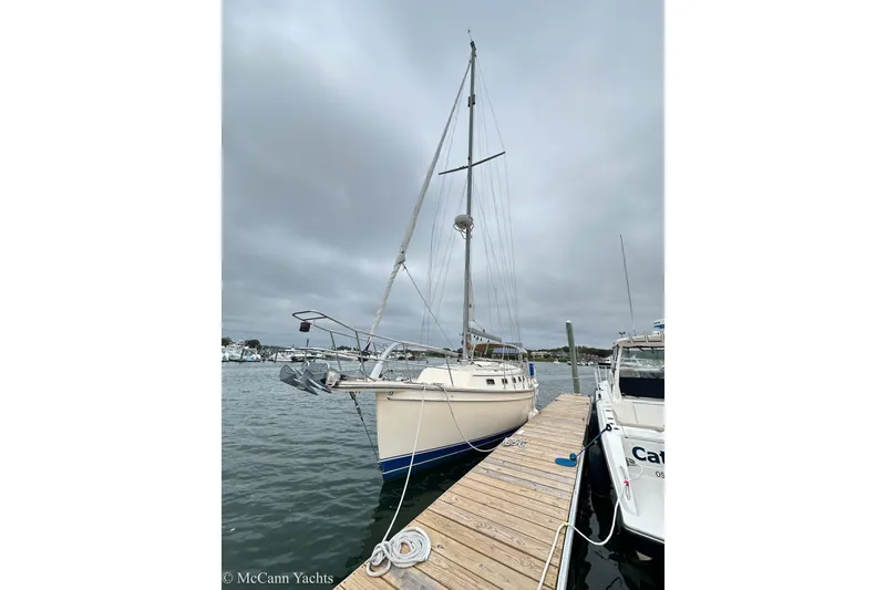 Slide: The Image of 2010 Island Packet Estero sailboat docked on a cloudy day. - 13