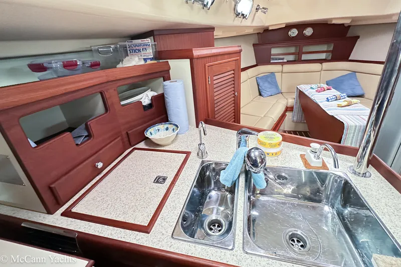 Slide: The Image of 2010 Island Packet Estero yacht interior with kitchen sink and cozy seating area. - 14