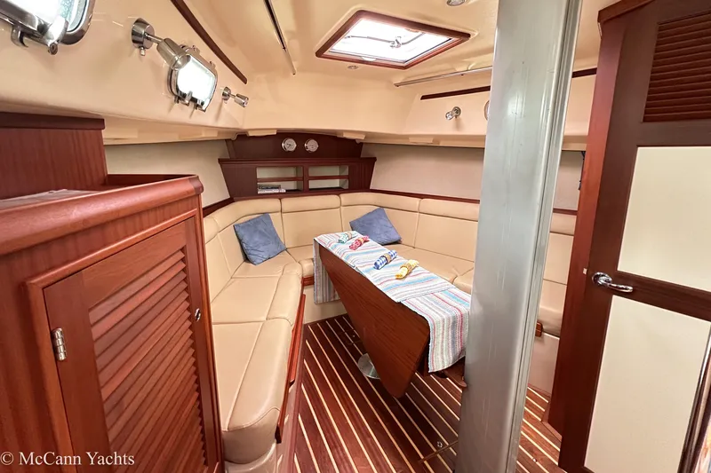 Slide: The Image of Luxurious 2010 Island Packet Estero yacht interior with cozy seating and elegant wood finishes. - 15