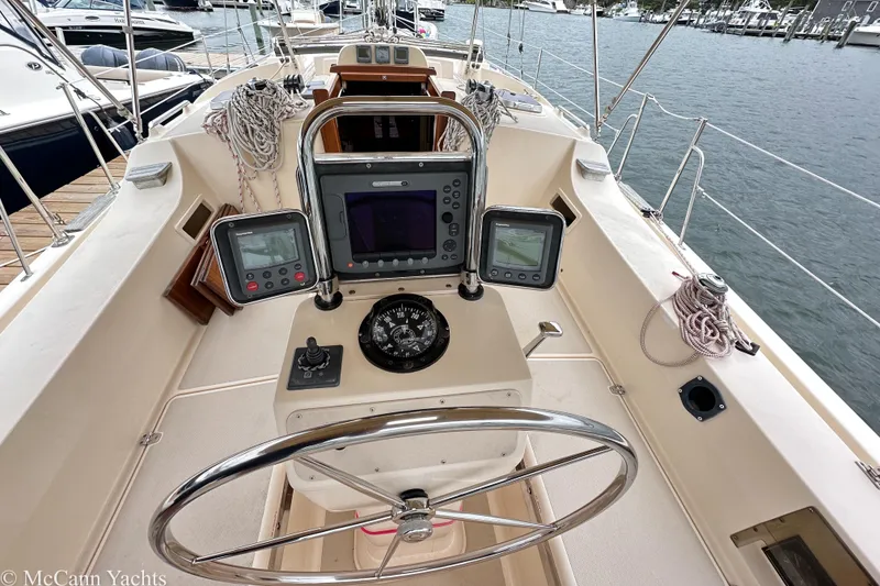 Slide: The Image of 2010 Island Packet Estero yacht cockpit with navigation instruments and steering wheel. - 2