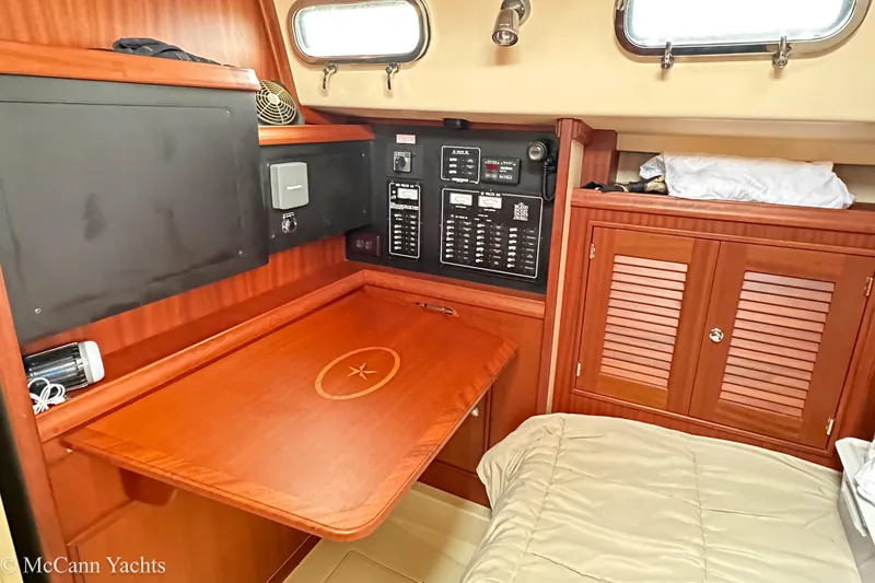 Slide: The Image of 2010 Island Packet Estero yacht interior with navigation panel and wooden cabinetry. - 21