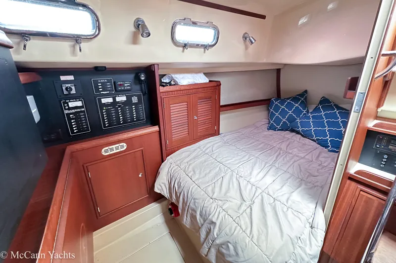 Slide: The Image of Cozy cabin interior of 2010 Island Packet Estero yacht with bed and control panel. - 28