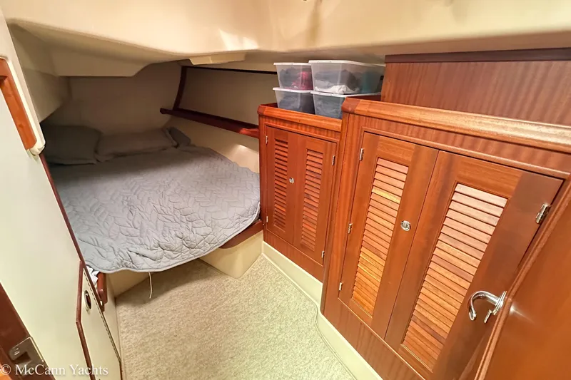 Slide: The Image of Cozy cabin interior of 2010 Island Packet Estero yacht with bed and wooden storage cabinets. - 31