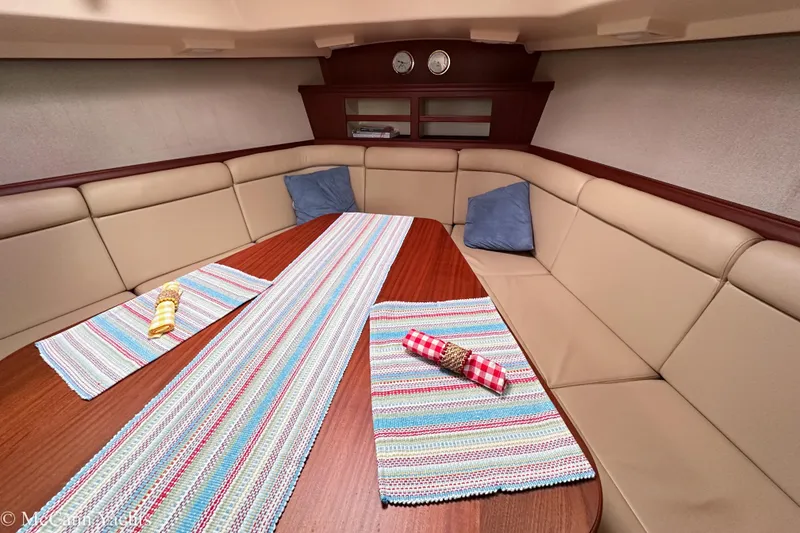 Slide: The Image of 2010 Island Packet Estero interior with cozy seating and colorful table runners. - 34