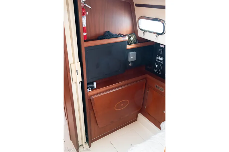 Slide: The Image of 2010 Island Packet Estero yacht interior with wooden cabinetry and porthole window. - 38