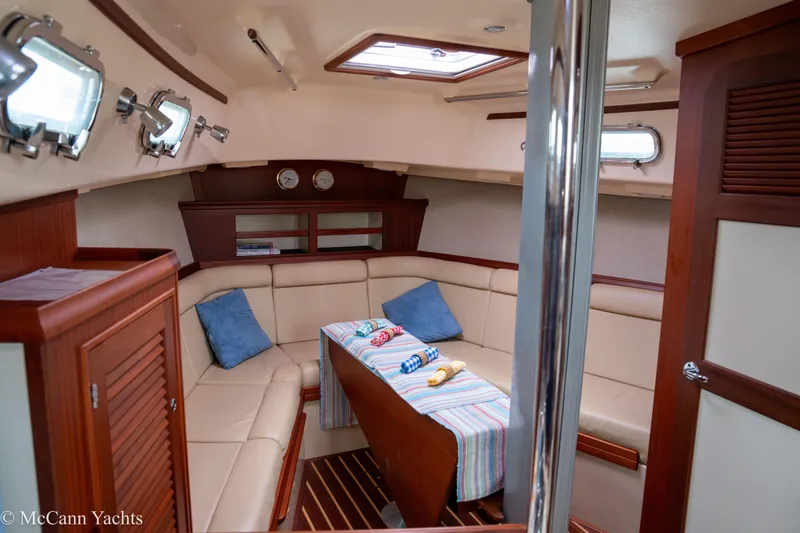 Slide: The Image of 2010 Island Packet Estero yacht interior with cozy seating and nautical decor. - 43