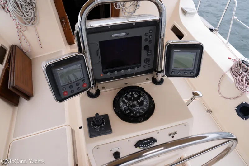 Slide: The Image of 2010 Island Packet Estero yacht cockpit with navigation instruments and steering wheel. - 48