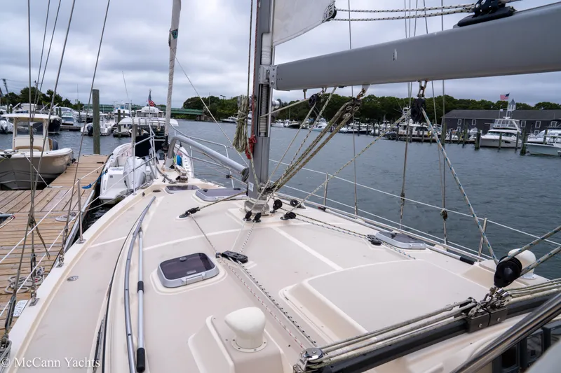 Slide: The Image of 2010 Island Packet Estero sailboat docked at a marina, showcasing deck and rigging. - 50