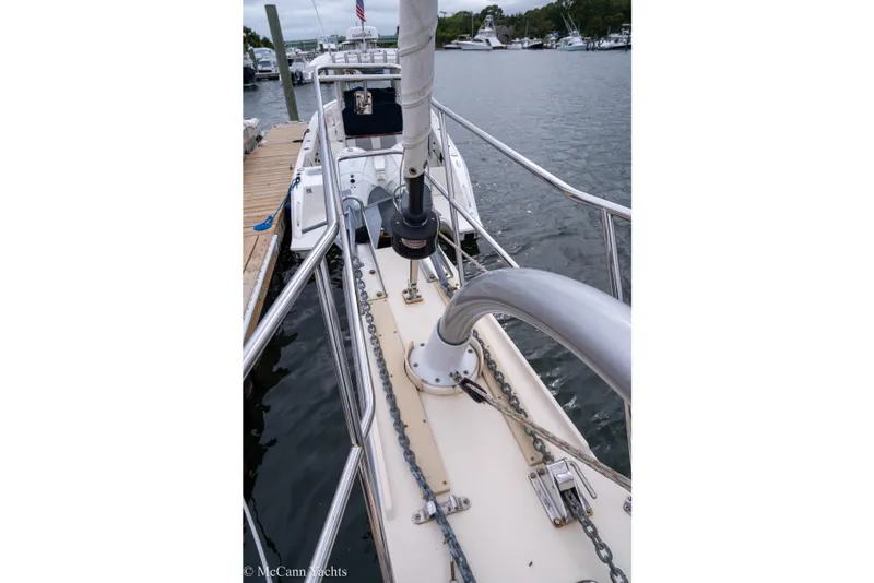 Slide: The Image of 2010 Island Packet Estero sailboat docked at marina, showing deck and railing details. - 52