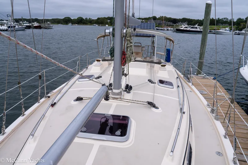 Slide: The Image of 2010 Island Packet Estero sailboat docked at marina, showcasing deck and rigging. - 53
