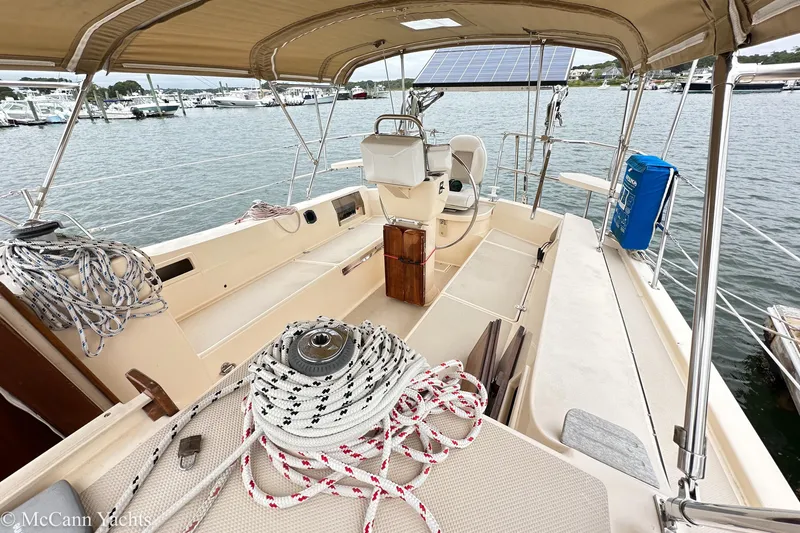 Slide: The Image of 2010 Island Packet Estero sailboat cockpit with ropes and solar panel, docked at marina. - 7