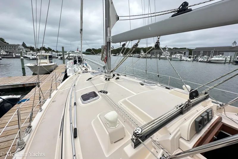 Slide: The Image of 2010 Island Packet Estero sailboat docked at a marina, showcasing deck and rigging. - 8