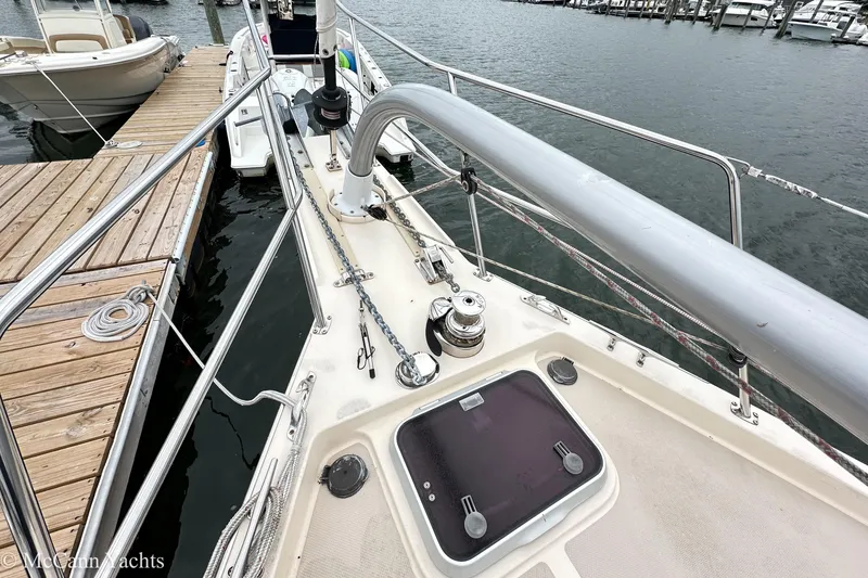Slide: The Image of 2010 Island Packet Estero sailboat deck at marina, featuring winch and hatch. - 9