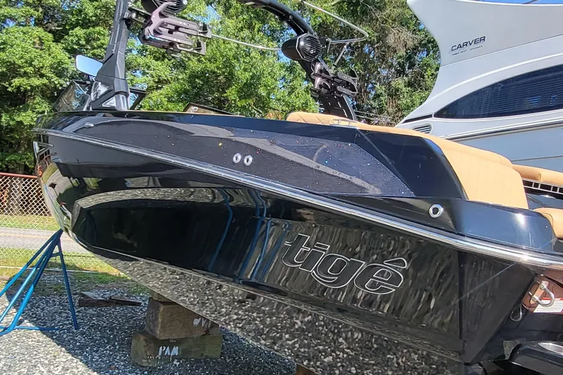 Slide: The Image of 2023 Tigé Z3 boat with sleek black design, displayed outdoors. - 11