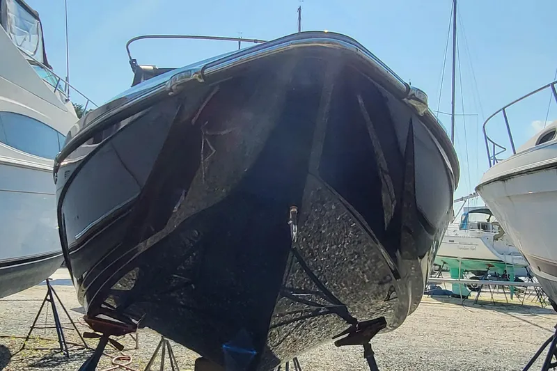 Slide: The Image of 2023 Tigé Z3 boat in dry dock, front view, surrounded by other vessels. - 12