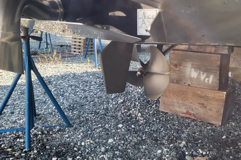 Slide: The Image of 2023 Tigé Z3 boat propeller on gravel with wooden supports. - 16