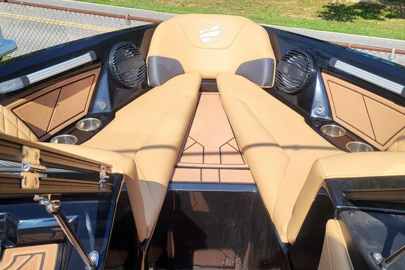Slide: The Image of 2023 Tigé Z3 boat interior with tan seating, cup holders, and speakers. - 19