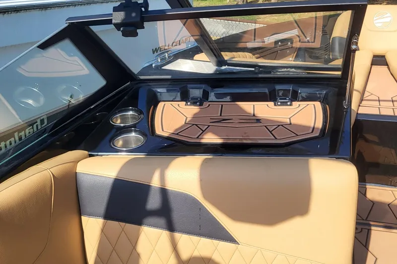 Slide: The Image of 2023 Tigé Z3 boat interior with tan upholstery and cup holders. - 20