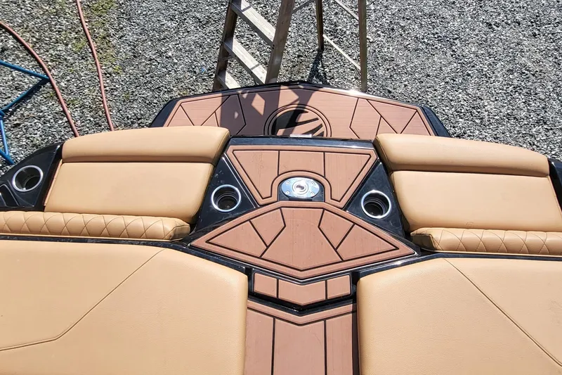 Slide: The Image of 2023 Tigé Z3 boat interior with tan seating and cup holders, viewed from above. - 7