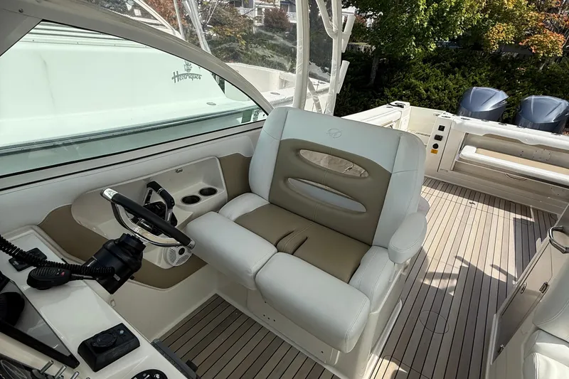 Slide: The Image of 2016 Sailfish 325 DC boat interior with helm seat and steering wheel. - 11