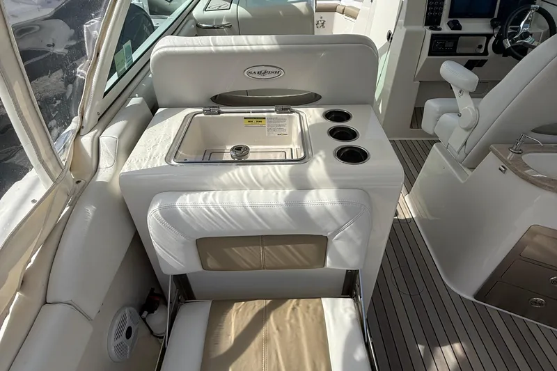 Slide: The Image of Interior of a 2016 Sailfish 325 DC boat featuring a sink and cup holders. - 12