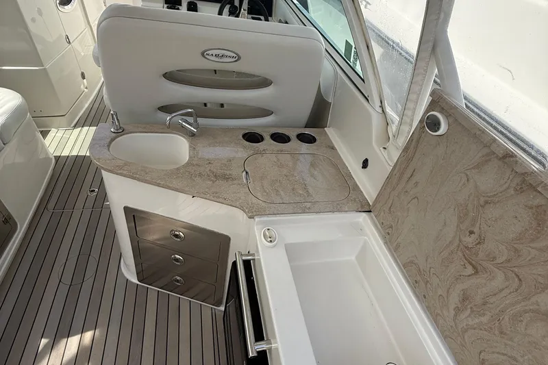 Slide: The Image of Interior of 2016 Sailfish 325 DC boat with sink, countertop, and storage drawers. - 14