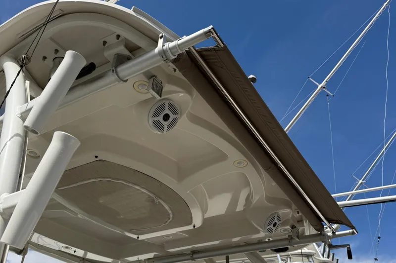 Slide: The Image of 2016 Sailfish 325 DC boat canopy and speakers under clear blue sky. - 22