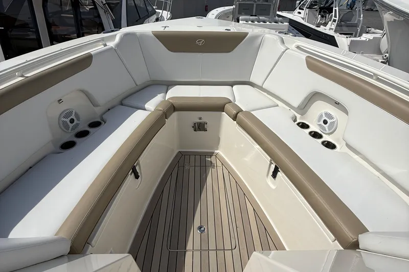 Slide: The Image of 2016 Sailfish 325 DC boat interior with cushioned seating and cup holders. - 8