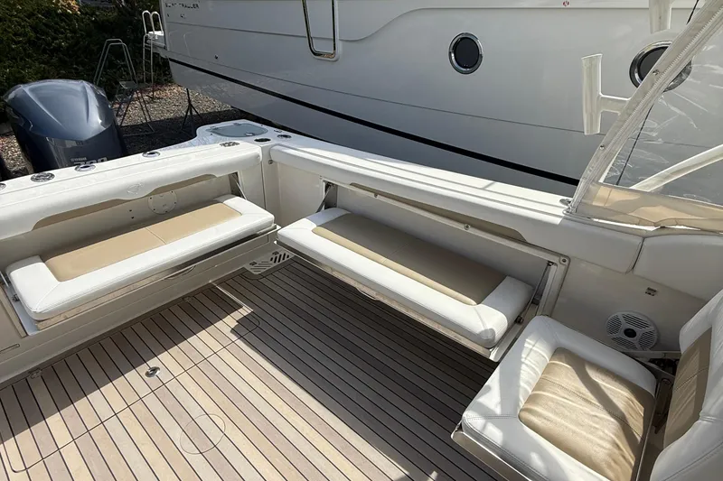 Slide: The Image of 2016 Sailfish 325 DC boat interior with cushioned seating and teak flooring. - 9