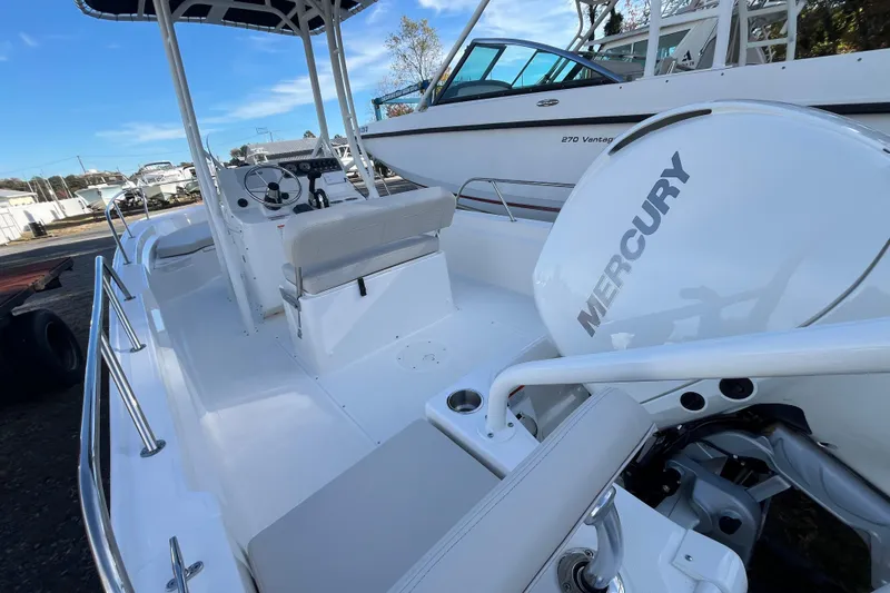 Slide: The Image of 2026 Boston Whaler 190 Montauk boat with Mercury engine, featuring spacious seating and modern design. - 17