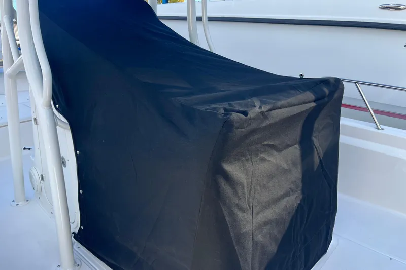 Slide: The Image of 2026 Boston Whaler 190 Montauk console covered with black fabric for protection. - 18