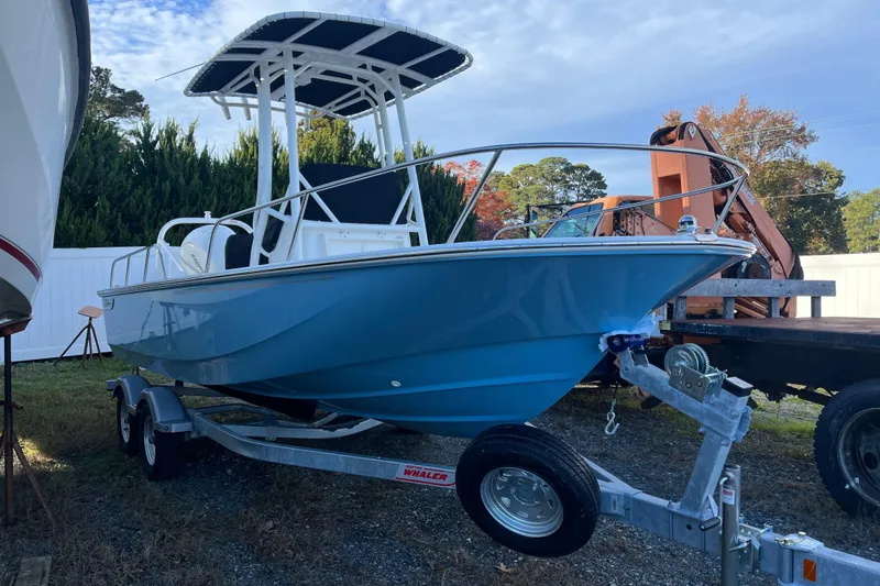 Slide: The Image of 2026 Boston Whaler 190 Montauk boat on trailer, blue hull, outdoor setting. - 19