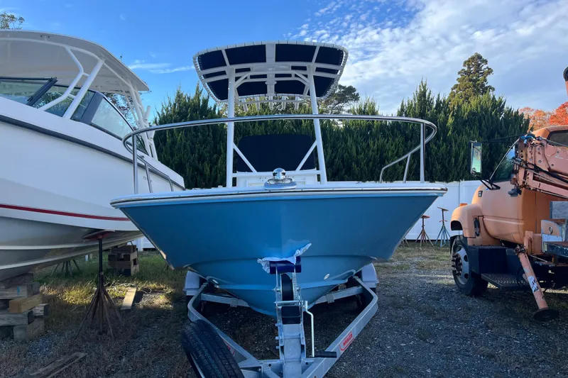 Slide: The Image of 2026 Boston Whaler 190 Montauk boat on trailer, parked outdoors. - 21