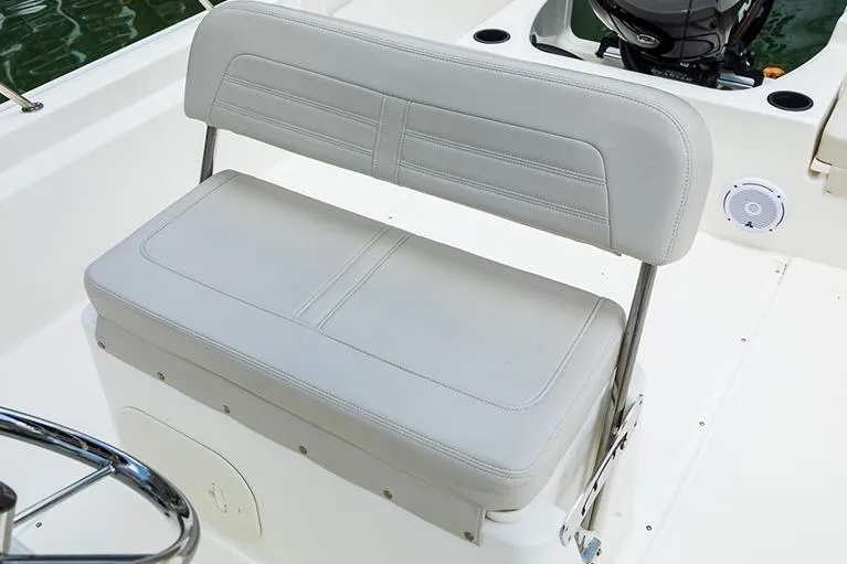 Slide: The Image of 2026 Boston Whaler 190 Montauk boat interior with Mercury engine, white seating, and railings. - 8